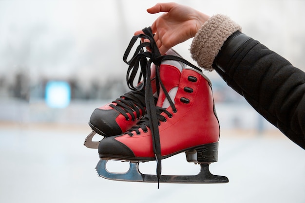 Side view woman holding ice skates