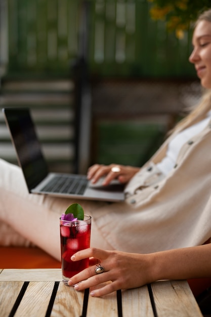 Side view woman holding laptop