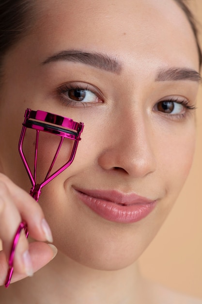 Side view woman holding lash curler