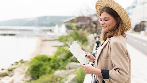 Side view woman holding map