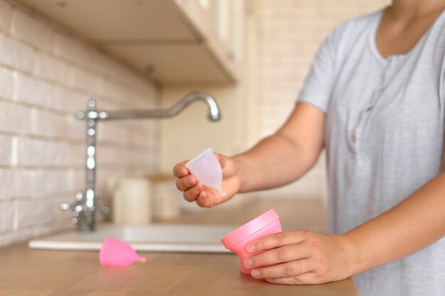 Side view woman holding menstrual cup