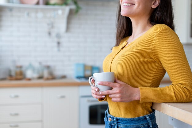 Side view of woman holding a mug