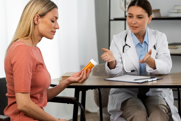 Side view woman holding pills container