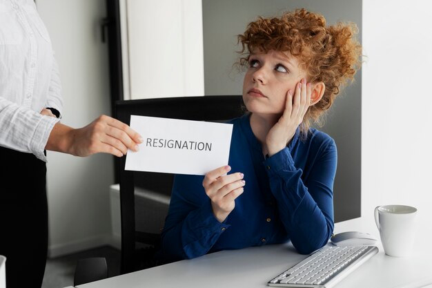 Side view woman holding resignation note