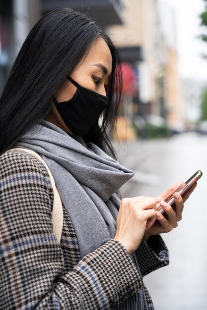 side view woman holding smartphone