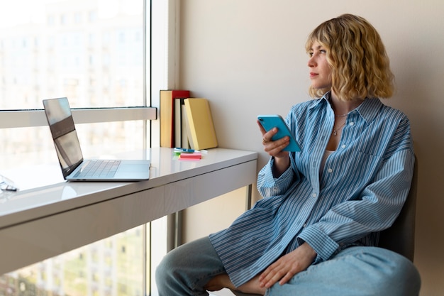 Side view woman holding smartphone