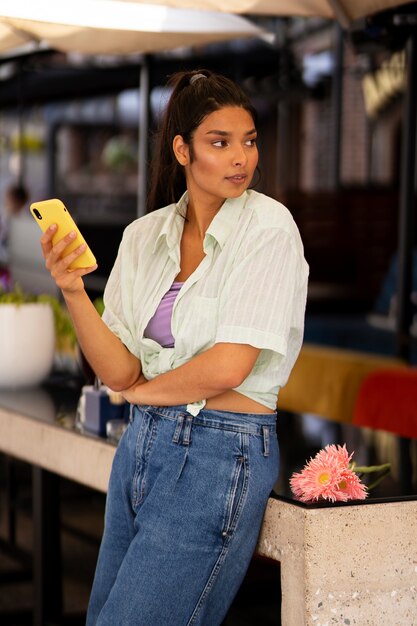Side view woman holding smartphone