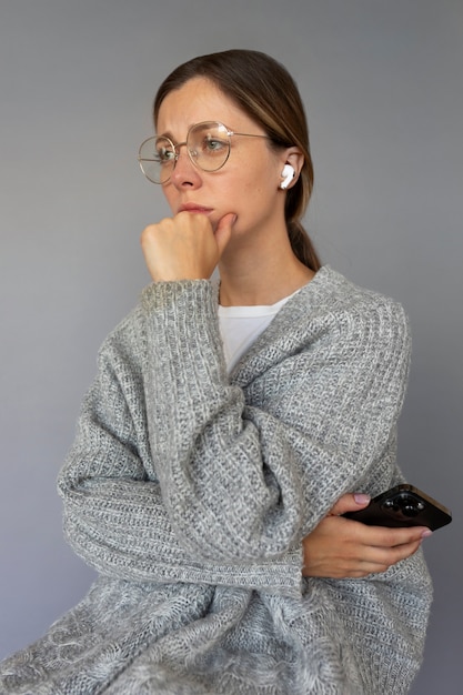 Free photo side view woman holding smartphone