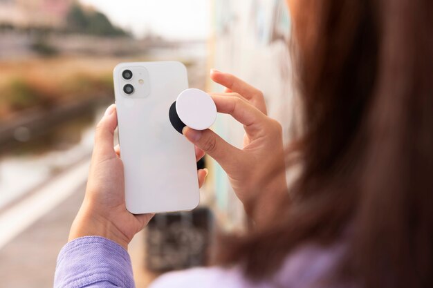 side view woman holding smartphone