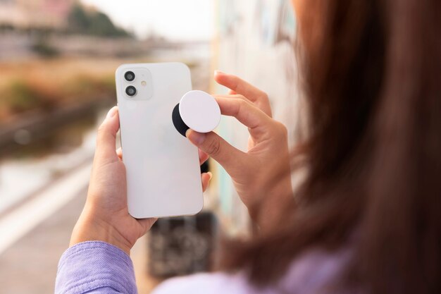 Side view woman holding smartphone