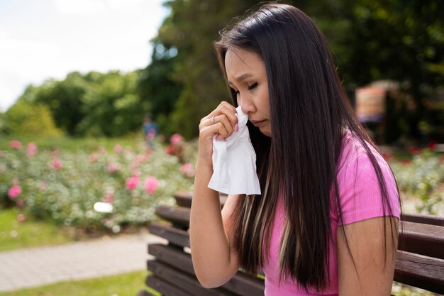 side view woman holding tissue