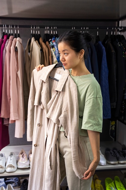 Side view woman holding trench coat