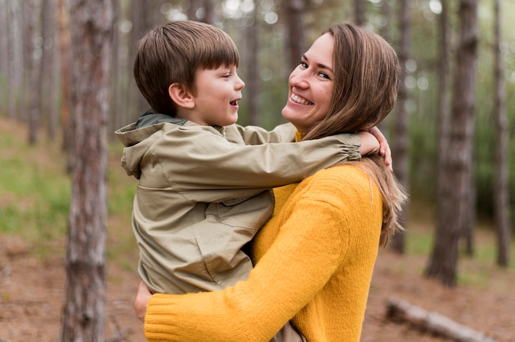 Free Photo side view woman holding up her son