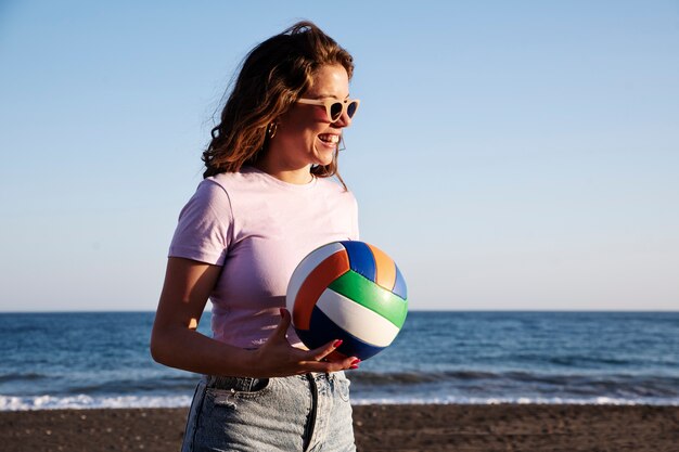 Side view woman holding volleyball