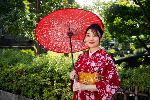 Side view woman holding wagasa umbrella