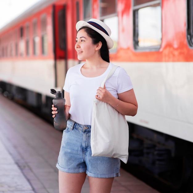 Side view woman holding water bottle