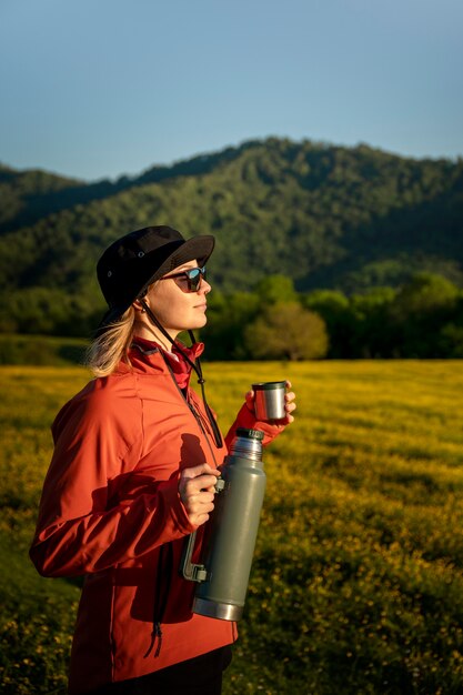 Side view woman holding water flask