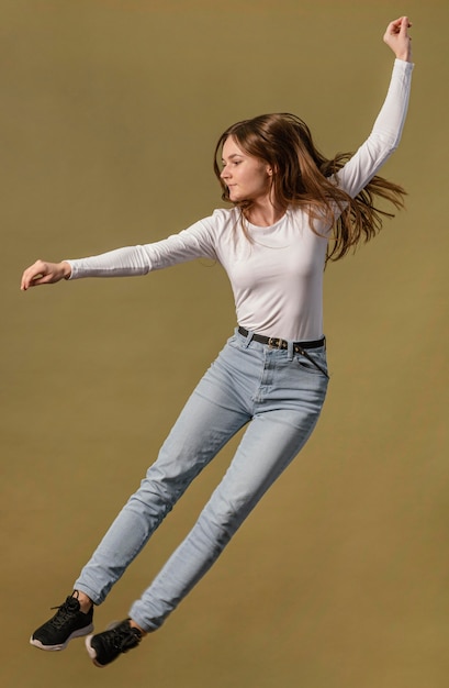Side view of woman jumping in the air