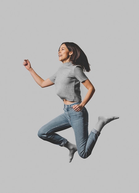 Side view of woman jumping in the air