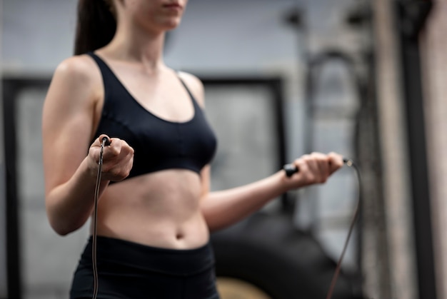 Side view of woman jumping rope