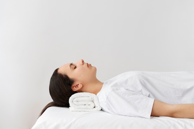 Side view woman laying on bed