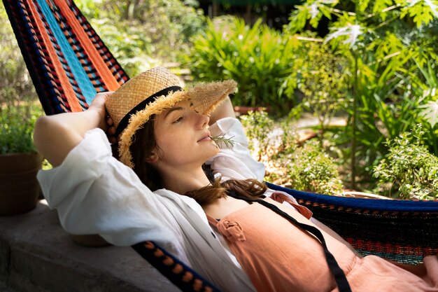 Side view woman laying in hammock