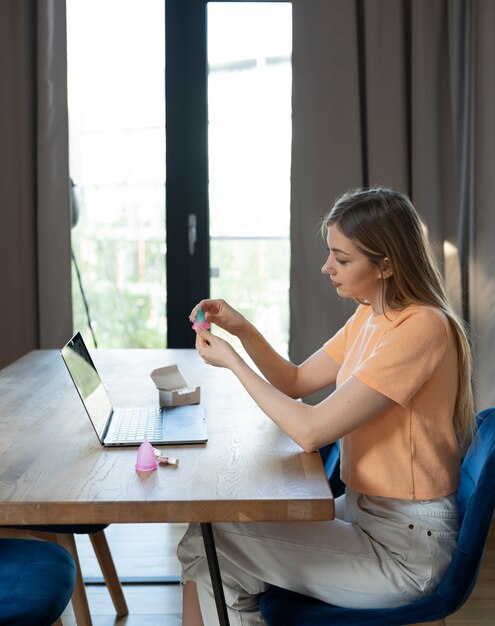 Side view woman learning about menstrual cup