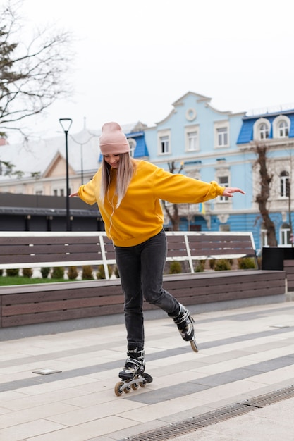 Side view of woman learning how to roller blade