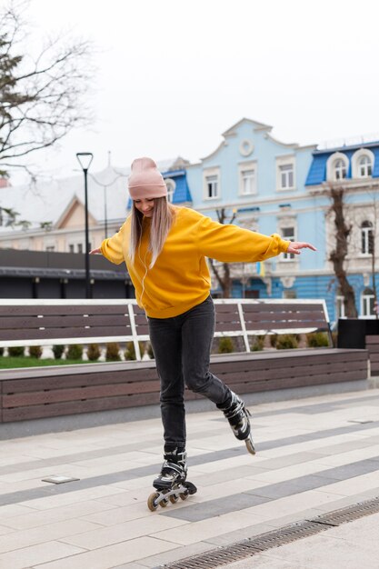 Side view of woman learning how to roller blade