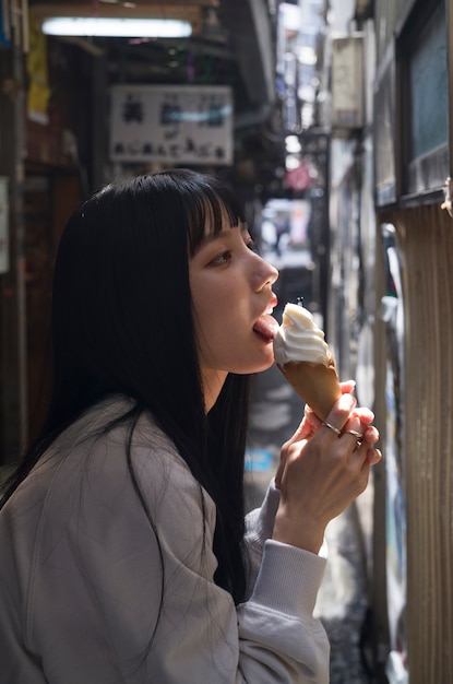 Side view woman licking ice cream cone