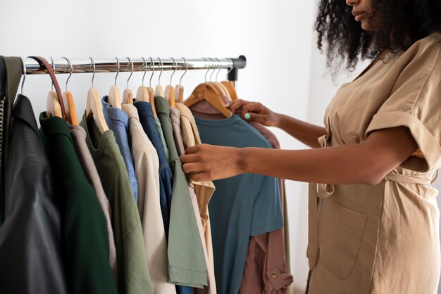 Side view woman looking at clothes