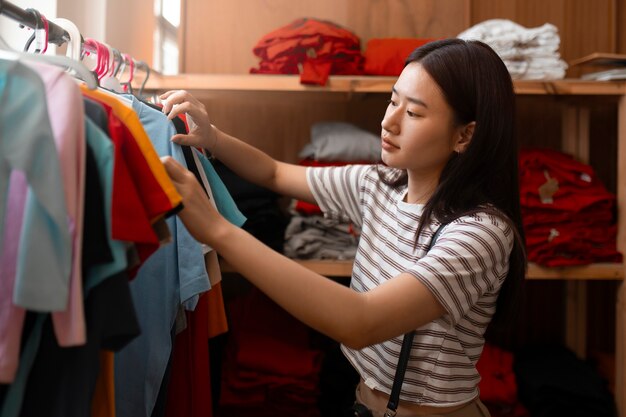 Side view woman looking at clothes