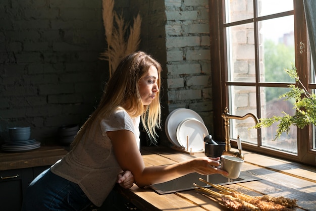 Side view woman looking at a cup