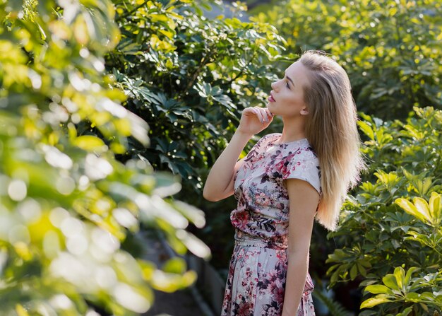 Side view woman looking at plants leaves