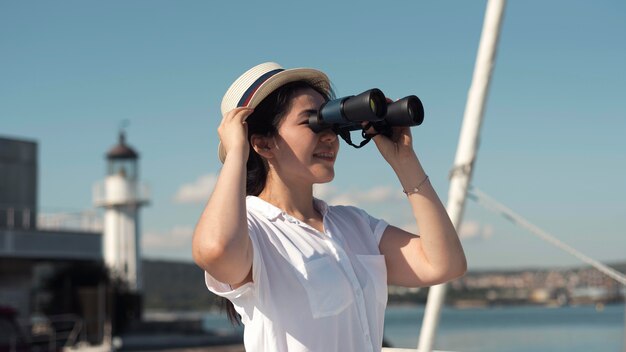 Side view woman looking through binoculars