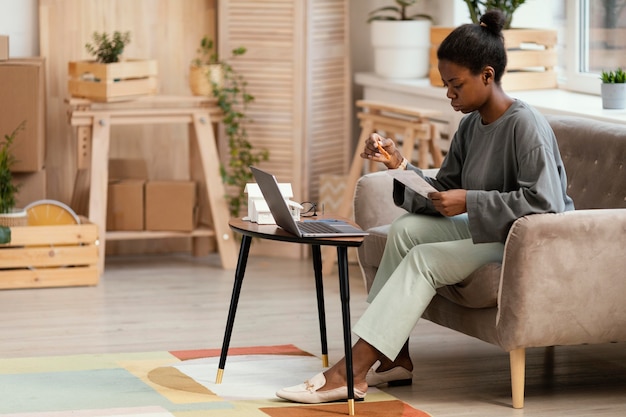 Side view of woman making plans to redecorate home