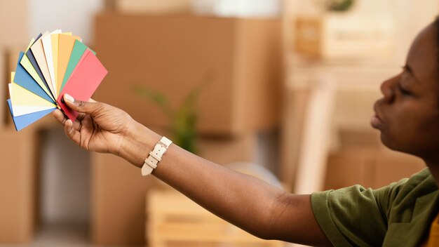 Side view of woman making plans for renovating home using color palette