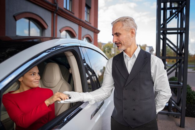 Free photo side view woman and man holding car key