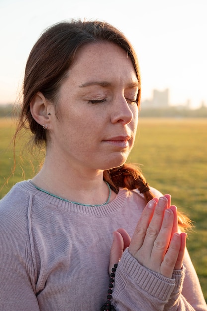 Side view of woman meditating outdoors