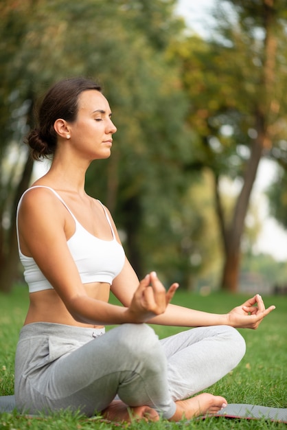 Side view woman meditating with closed eyes