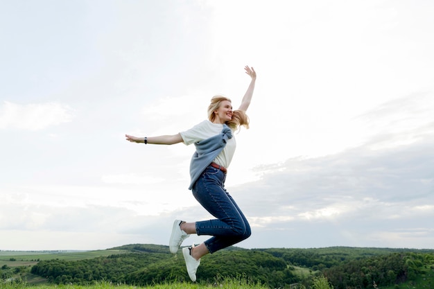 Side view of woman in nature posing mid-air