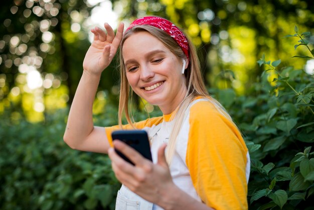 Side view of woman outdoors listening to music