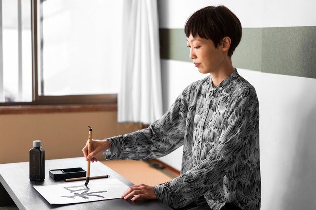 Side view woman painting with brush