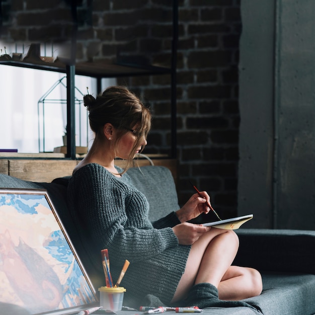 Side view of woman painting