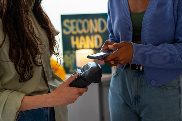 Side view woman paying with card