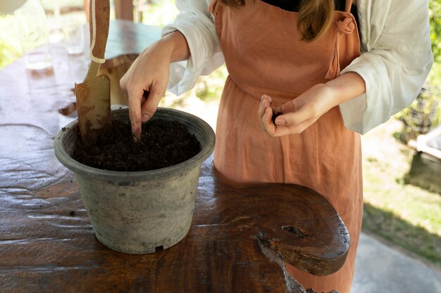 Side view woman planting seeds