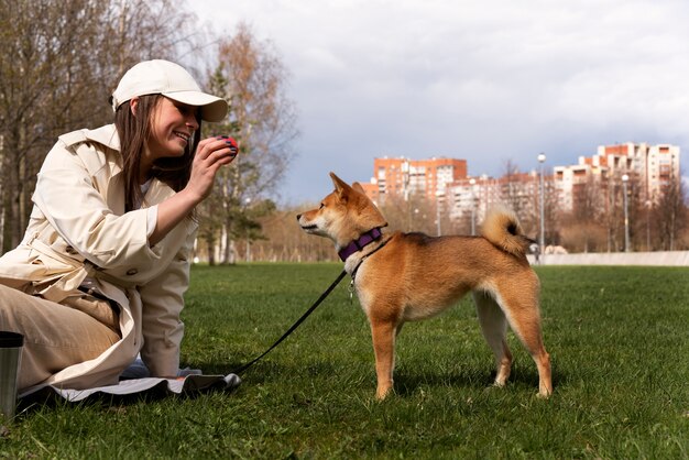 かわいい犬と遊ぶ側面図の女性