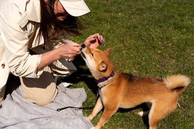 Side view woman playing with dog