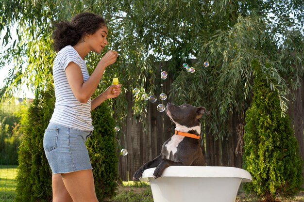 Side view woman playing with dog