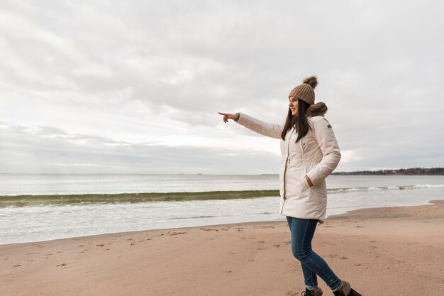 Side view woman pointing at distance